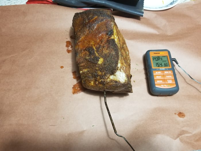 The pork has been in the smoker for almost 6 hours. A good amount of crust, or bark, is visible. Once it hits the stall, it's time to wrap it in butcher paper.