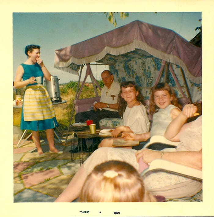 Mom to the left, me squinting in the middle and my sister next to me at a taco feed/swim party.