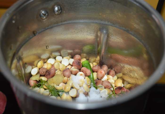 Step two: Add fried peanut, fried gram, broken green chilies, chopped ginger, tamarind pulp, and salt to a mixer jar.