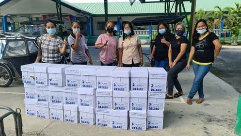 Teachers receive their supplies for the printing of modules funded by school MOOE.