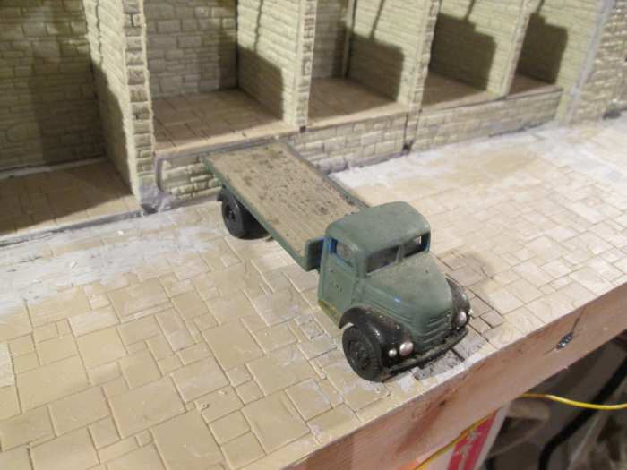 ... And to show the width of the depot yard after adding pine strips to the front of the layout, here's oner of the 'Classix' range of commercial vehicles, a flatbed delivery lorry backed up to a cell for loading