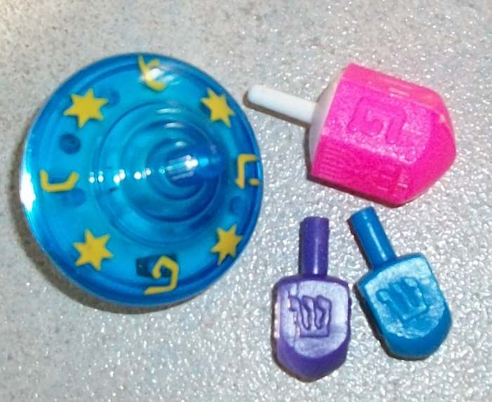Round musical sevivon and pink sevivon are from Israel. You see letter "Pey". Purple and blue dreidels have letter "shin", we got them in America