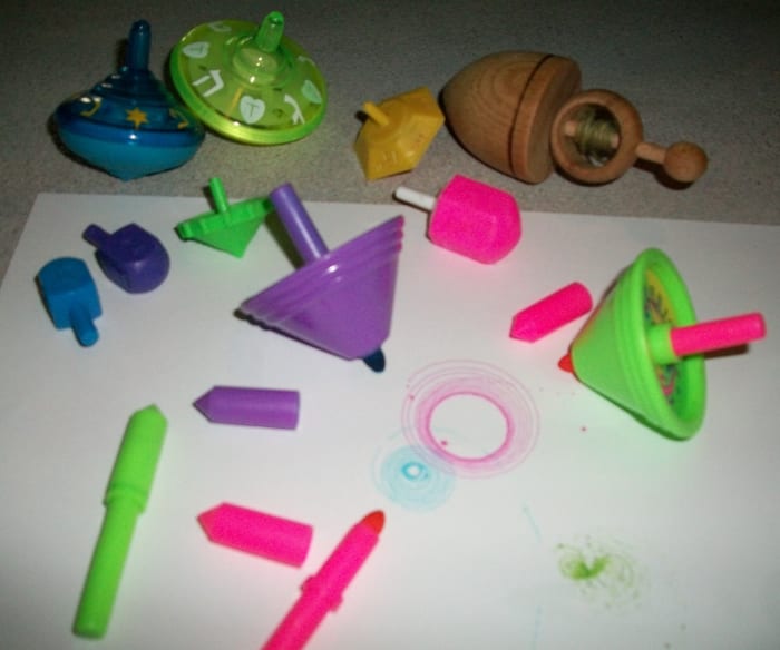 Leftovers of Reuven's dreidels. He used to have a whole box! Musical dreidels, dreidels that draw circles, etc.
