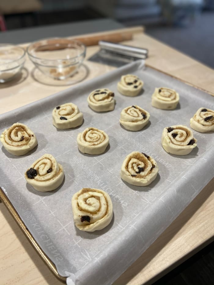 Place the Danishes onto a prepared parchment-lined baking tray. Remember to tuck each end underneath.