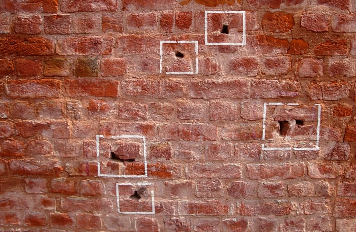 Just a few of the million bullet holes still present in Jallianwala Bagh till today (marked with chalk)