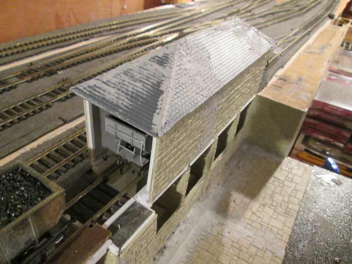 View of the lime shed to get you up-to-date. Ridge tiles, guttering and downpipes to add before painting. Wills' (Peco) Slate Roofing sheets were used for the roof and an amount of filler to disguise the gaps. Empty hopper in the lime she