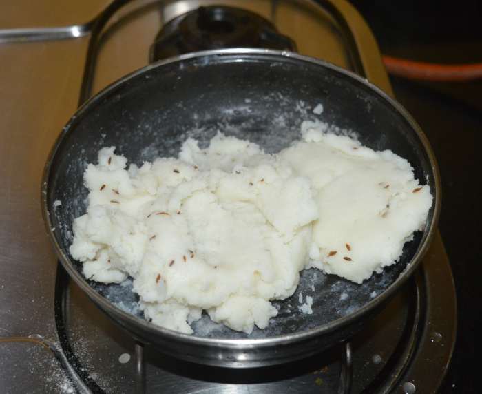 Turn off the heat when the mixture comes like a single unit. Transfer it to a plate. Knead it to form a soft and pliable dough ball. Cover and set aside.