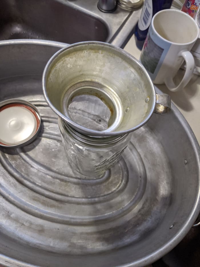 I'm going to use a metal funnel to help dump it into the jars. I had enough to fill a quart jar, and a pint jar. Save the fluid
