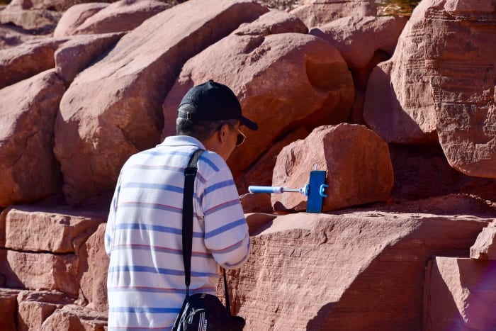 While there aren't that many uses for a selfie stick, it can serve other purposes than just snapping arm-length selfies, such as acting as a makeshift phone stand.