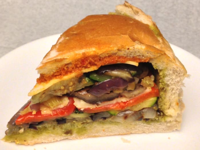 Veggie sandwich with grilled eggplant, zucchini, portabella mushroom, red onion, red pepper, provolone and pesto