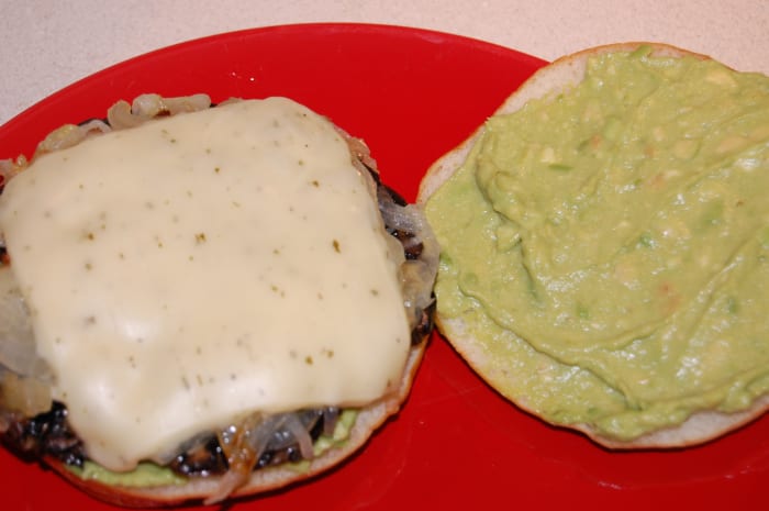 Portabella sandwich made on Oraweat sandwich thins with avocado, caramelized onion, garlic herb cheese, and portabella cap