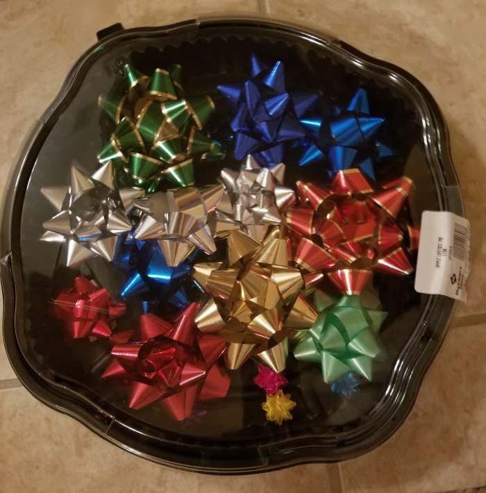 Save your Thanksgiving pie container. Protect your stored bows by putting them in one of these. It keeps them from getting crushed or dusty, and you can easily see what you have for wrapping gifts.