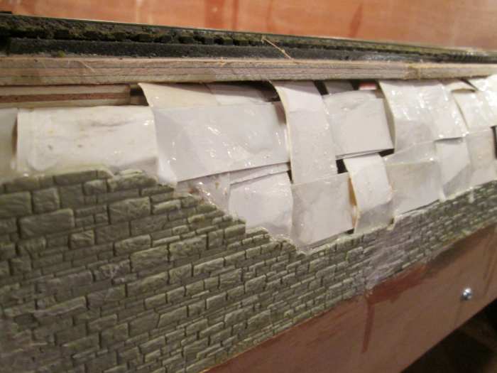 ... Beginning with vertical strips of card made pliable by bending, glued in place with strong wood glue, and adding horizontal strips over- and underlapped to strengthen the surface before I add 'Modoc', plaster impregnarted muslin sheet in strips