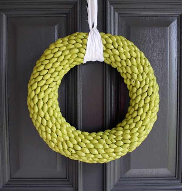 The chartreuse wreath is painted. These caps were taken off the acorns. It is made the winter wreath with a ribbon on the front door.