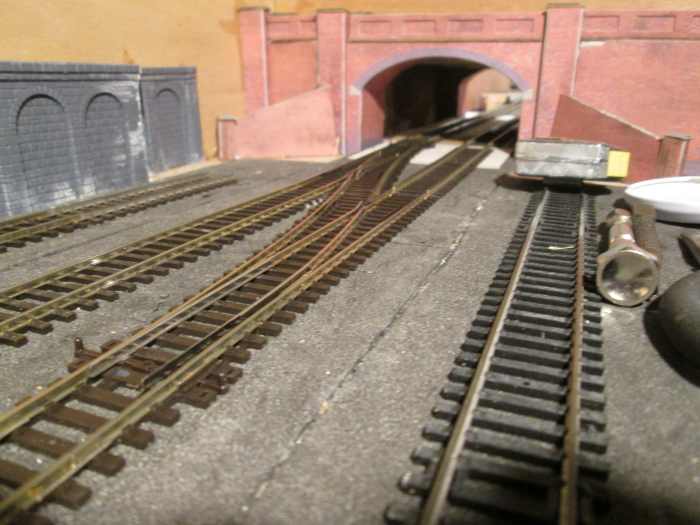 This view toward the narrow road bridge shows the facing left-hand points, the Down side point being under the bridge.
