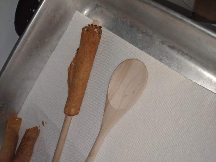 Pick up and move to paper towel lined plate. Do not remove spoon handle. Use two spoons, so you can let one cool while you do another krumkake.
