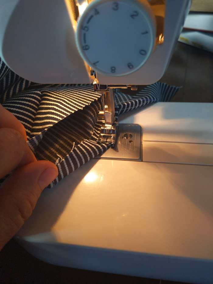 Fold over cut edge and sew about a 1/4 inch in. This gives you a nice hemmed edge later., And a line to follow.