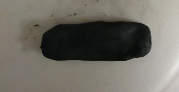 It is easier to choose black polymer clay to shape, but you may choose white clay and then paint black.