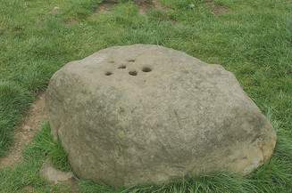 The Boundary Stone with holes drilled into the top to fill with vinegar to disinfect coins.