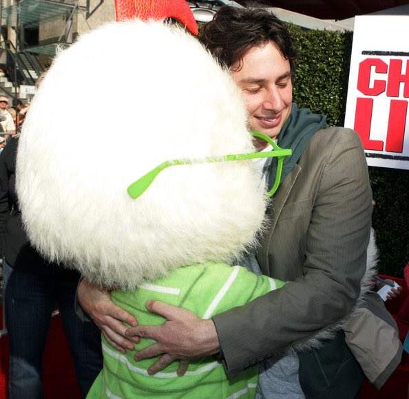 Zach Braff (voice actor for Chicken Little) hugging Chicken Little mascot at the Chicken Little (2005) movie premiere