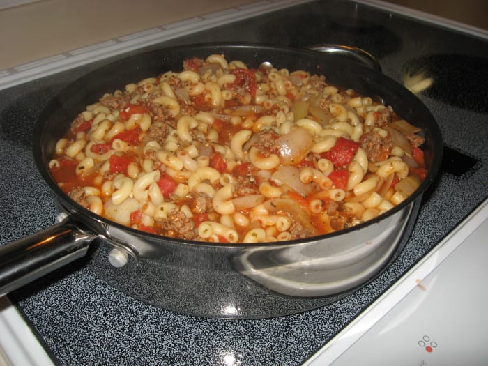 My husband's family calls this American Chop Suey. You would use several boxes of mac & cheese for a big batch like this. The cheese powder gets added in at the end.