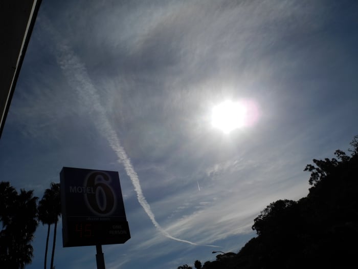 San Diego/ Approximately 10:30 am. This is a chemtrail that is morphing into a larger cloud like construct, but shown against an already Chemtrailed milky sky. Notice the consistency of the clouds in the background is different to REAL Clouds.