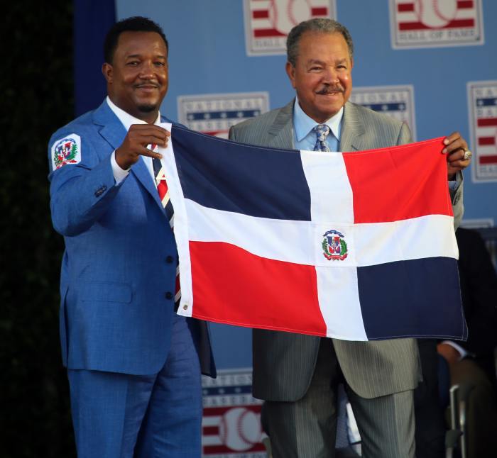 Pedro Martinez (left) and Juan Marichal hold the flag of the Dominican Republic after Martinez became the second native of the island to be inducted to the Hall of Fame. Marichal and Martinez were joined by Vladimir Guerrero in 2018.