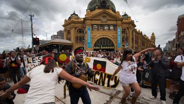 Hundreds of Invasion Day protesters march at the back of the Australian Day Parade in Melbourne's CBD. Photo: Jason South