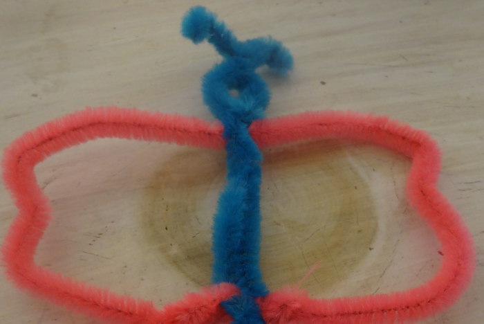 Cut any remaining pieces off the bottom, twist them together and with your fingers shape the wings so they resemble butterfly wings