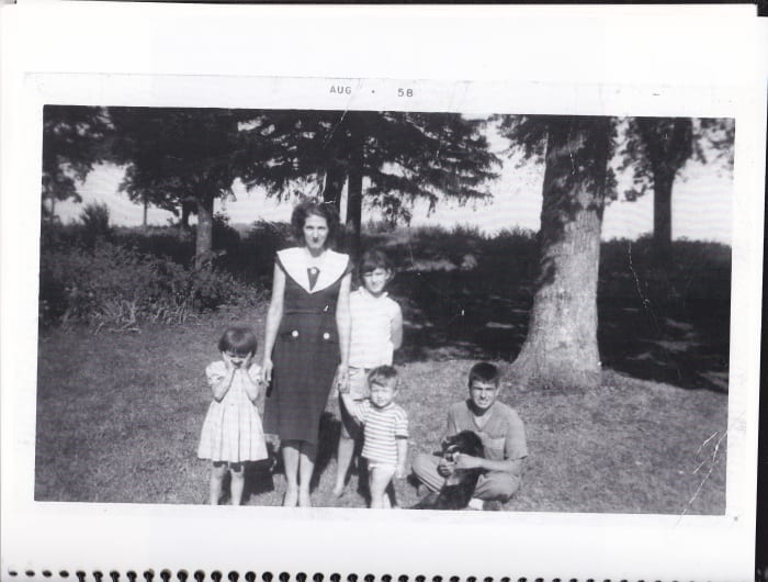 Author with mother, two sisters, and brother on front lawn of farmhouse. Taken in August 1958.