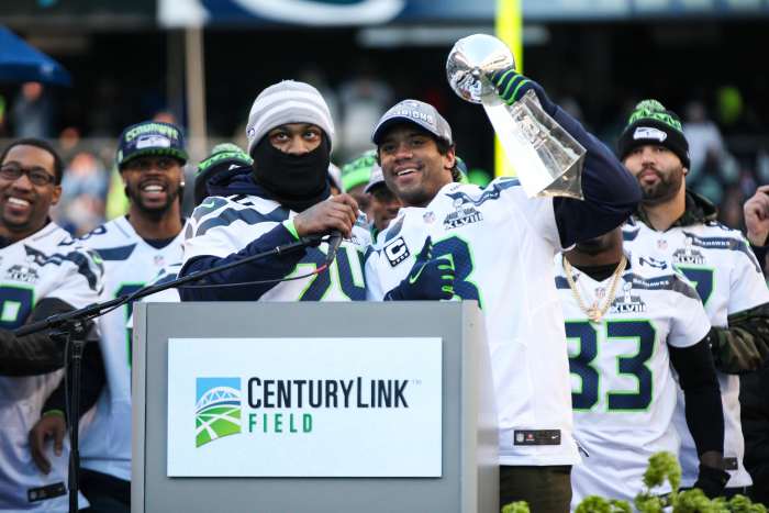 Russell Wilson (holding trophy) was a minor league baseball player within the Colorado Rockies organization.
