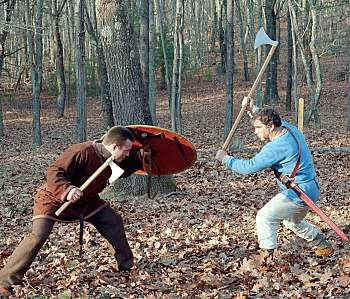 Axe combat. One man is armed with a Danish long-handled axe - these weapons could not be used easily in the shieldwall, and a man armed thus would need a comrade with shield and spear to watch his back