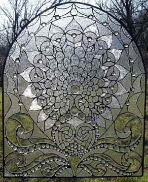 This stained glass panel has black lines surrounding each glass piece. That is due to the black patina which makes the colors stand out.