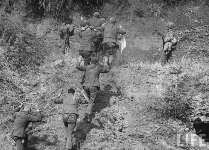 The 3rd ID taking exhausted and hungry Germans prisoner. Note the steep terrain of the Caesar Line.