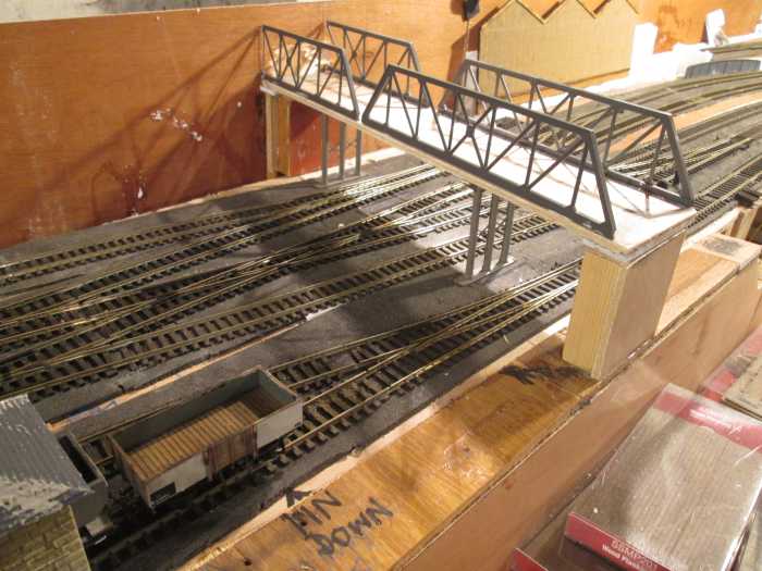 A truss girder bridge has been established down line from the coal & lime depot - I've toyed with the idea of adding an older level crossing next to it to give the impression the newer bridge superseded it. I'll have to work out the possibilities.