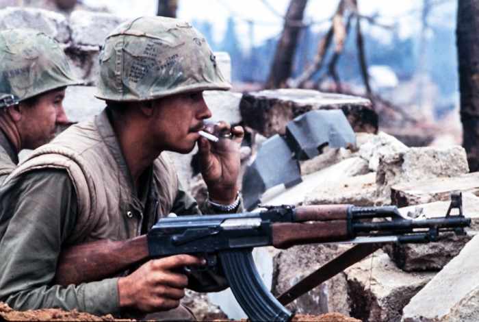 American Marine holds the main battle weapon of the North Vietnamese Army (NVA) the AK-47 during the battle for Hue.