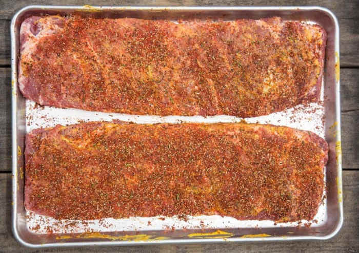 I apply very well over the top side of the rib then rub it in just like you're massaging something then flip it over then do the same now remember you can be generous with the rub.