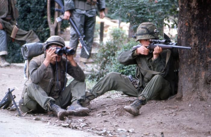 Marine sniper team searching for targets in Hue February 1968. Note in the background soldier with a bayonet on his M-16.