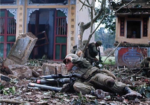 A Marine taking cover amid all the rubble by the end of the battle for Hue over 80% of the city was destroyed.