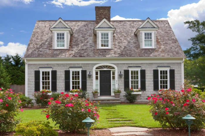 The Cape Cod is this style have a symmetrical, rectangular shape, a central chimney, dormers peeking out of a pitched roof and embellishments like shuttered windows and window boxes.
