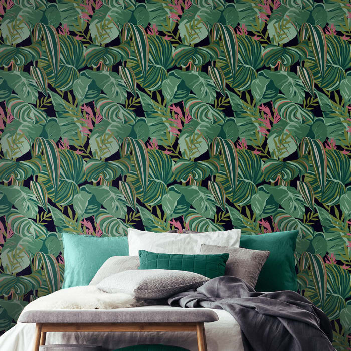 On a dark green backdrop, a beautiful matt digital picture of stylised painterly tropical leaves in shades of green, with pink detail, is suitable for that chic jungle look.