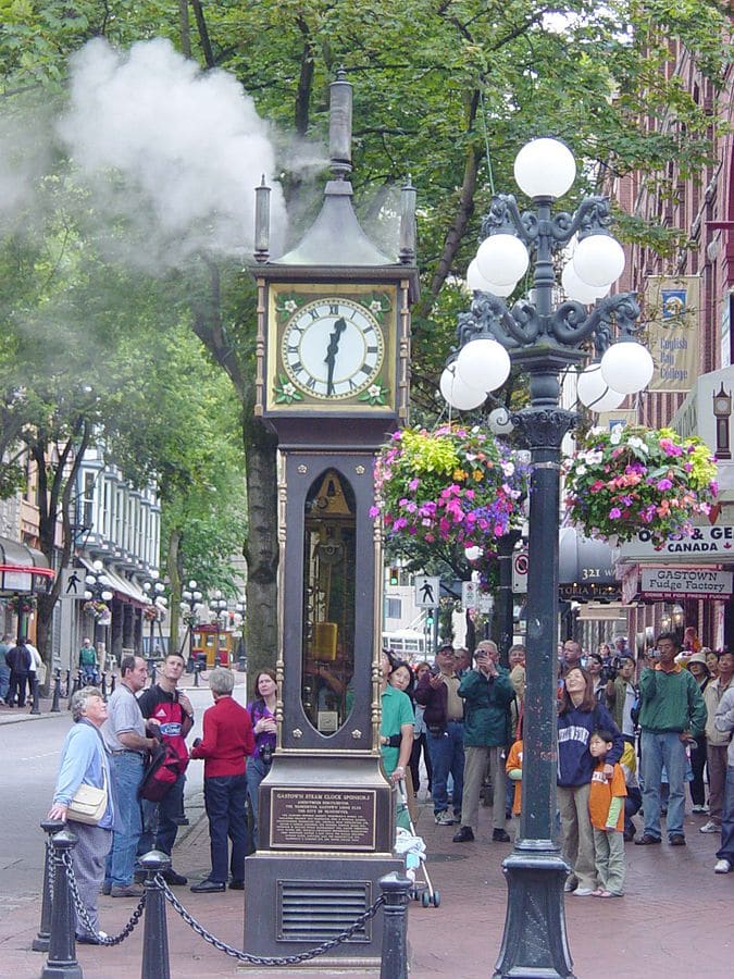 Tourists are entertained by the Gastown, Vancouver, Canada steam clock.