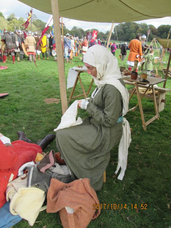 One of the womenfolk engages in homecraft as she awaits the return of her man/men. She'd hope to see them back but a long day's fighting lay ahead from mid-morning to evening light