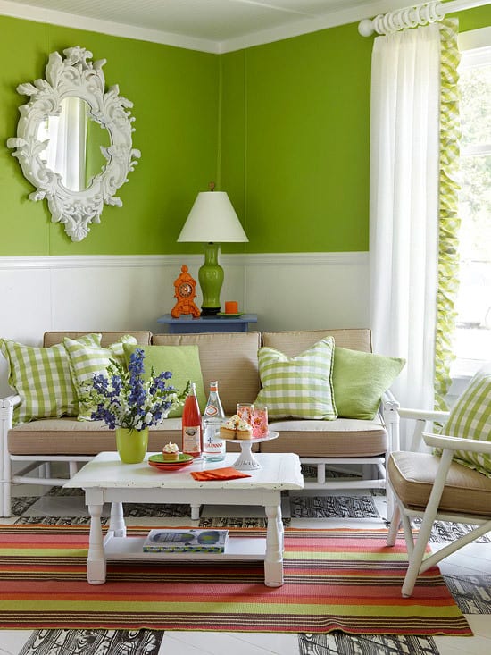Here, a apple green sofa and bright pillows pack a punch. The rug stripe orange, brown, green and pinks adds a feminine touch to the classic furnishings.