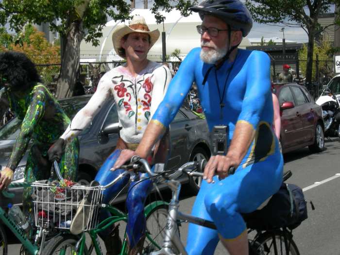 the traditional naked cyclist event in the summer solstice parade and pageant, Fremont Fair, Seattle, Washington.