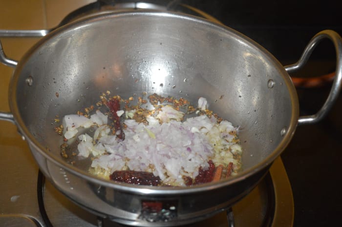 Step two: Add chopped onions. Increase the heat and saute until the onions become pinkish and transparent.