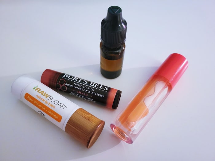 I've been using balm, and then gloss, and then balm again with no success. The champion is my DIY lip oil, pictured in the center amongst its fallen comrades.