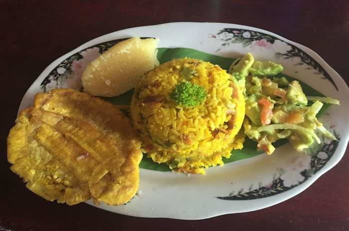 Fish Rice With Salad And Patacon (Fried Smashed Green Plantain). This dish is made with salted, dried mullet.