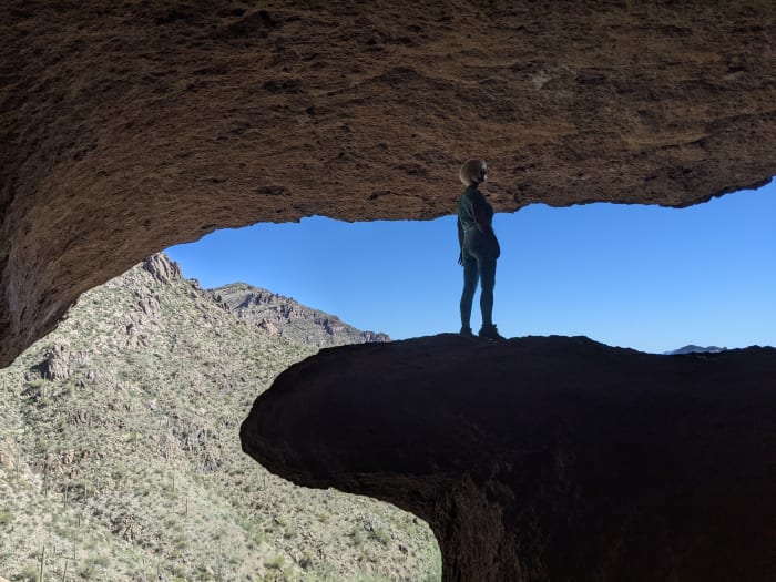 My wife standing on the rock platform at entrance to Wave Cave