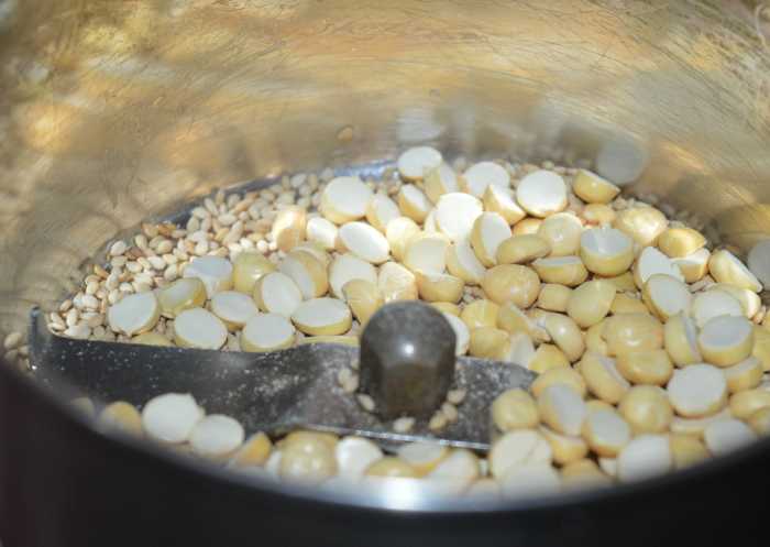 Add the sesame seeds and fried gram to a mixer. Grind to get a coarse powder. Collect it in a bowl and set aside.